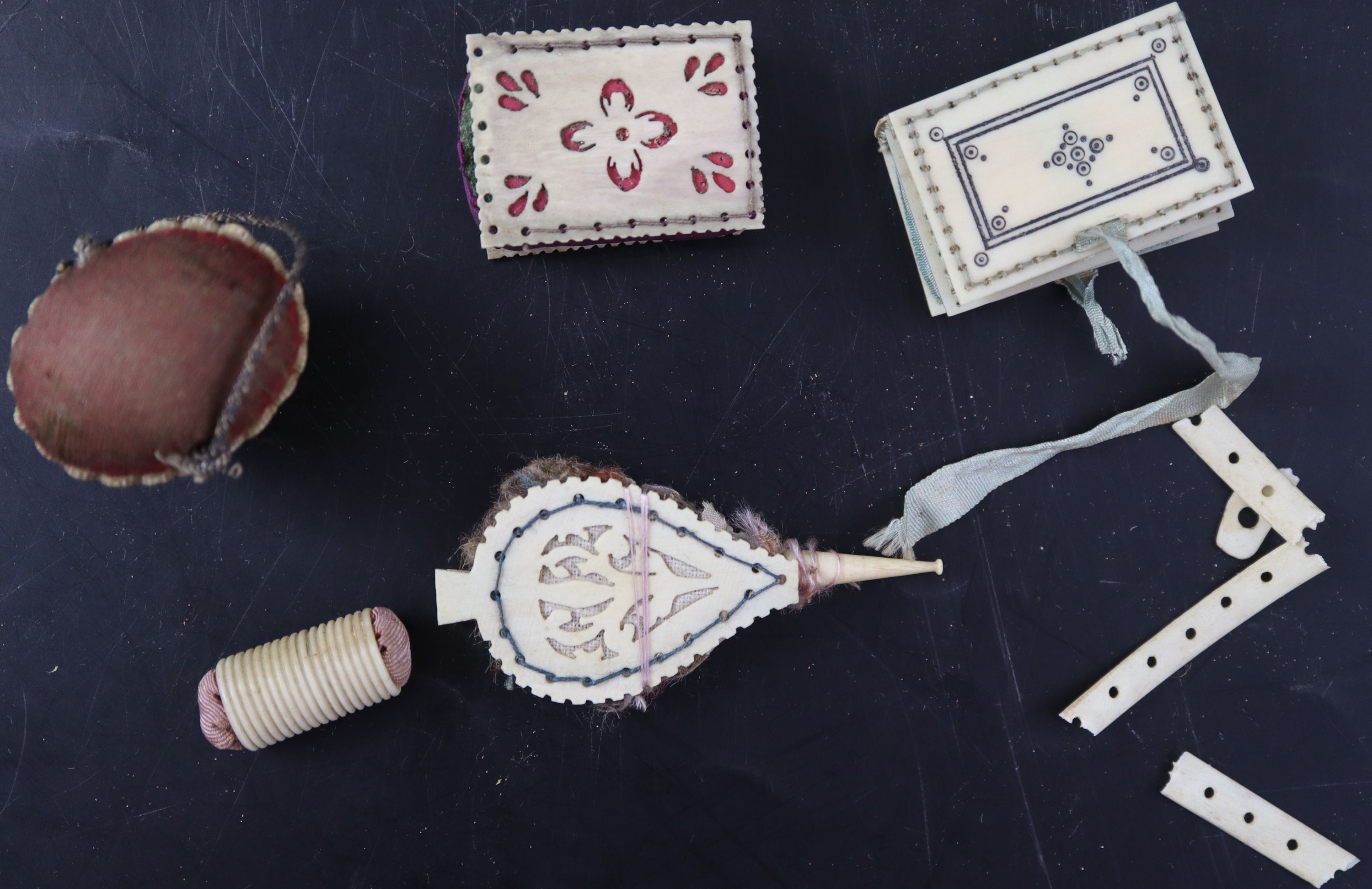 A collection of twelve 19th century carved ivory and bone pin cushions